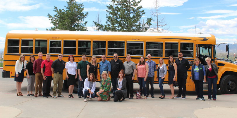 Group of members in front of a bus